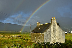 Derelict croft house and rainbow through a rain soaked window, Staffin, Isle of Skye