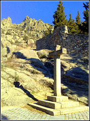 Cross by the monastery wall.