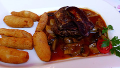 Grilled steak served with a slice of goose liver, burgundy sauce and home made potato croquette