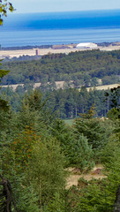 The hangar at what used to be RAF Kinloss, and the Moray Firth beyond from the hill up to Loch Romach