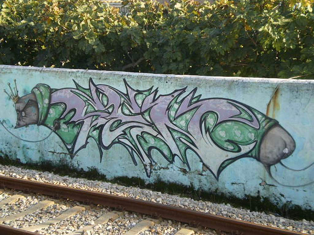 On wall close to the railway.