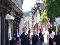 The guy in the suit is security for a big wedding of a billionaire's daughter, held this day at the old cathedral.  There were a lot of these guys standing around.