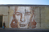 Portrait carved on wall by Vhils.
