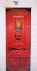 Sardines can painted on door.