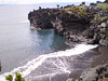 Tiny dark sand beach.