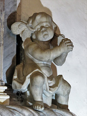 belchamp walter church, essex, cherub,C18 tomb listing members of the raymond family. erected before death of john raymond +1720, signed by robert taylor sen.