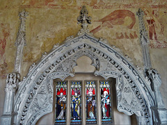 belchamp walter church, essex, john boutetort, c14 tomb canopy with square cut hole to cusps in line with tudor window. contemporary paintings cover the walls.c.1325