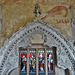 belchamp walter church, essex, john boutetort, c14 tomb canopy with square cut hole to cusps in line with tudor window. contemporary paintings cover the walls.c.1325