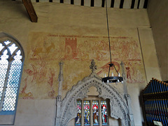 belchamp walter church, essex, john boutetort, c14 tomb canopy with square cut hole to cusps in line with tudor window. contemporary paintings cover the walls.c.1325