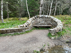 Stone seating by the pond in Evanton Woodland Trust