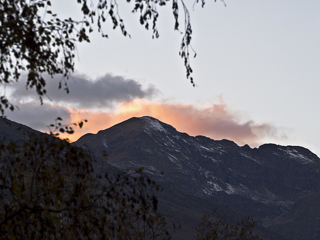 The first snow and the fire behind the mountain