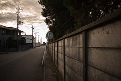 Road by the wall of a factory