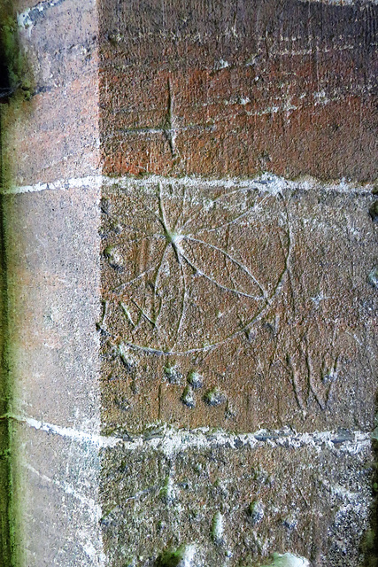 hazleton church, glos (12)daisy wheel graffiti in the porch; was it incised before the stone was cut to this shape?