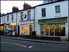 lighted shops on a grey afternoon