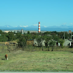 Stripy chimney and snowy mountains