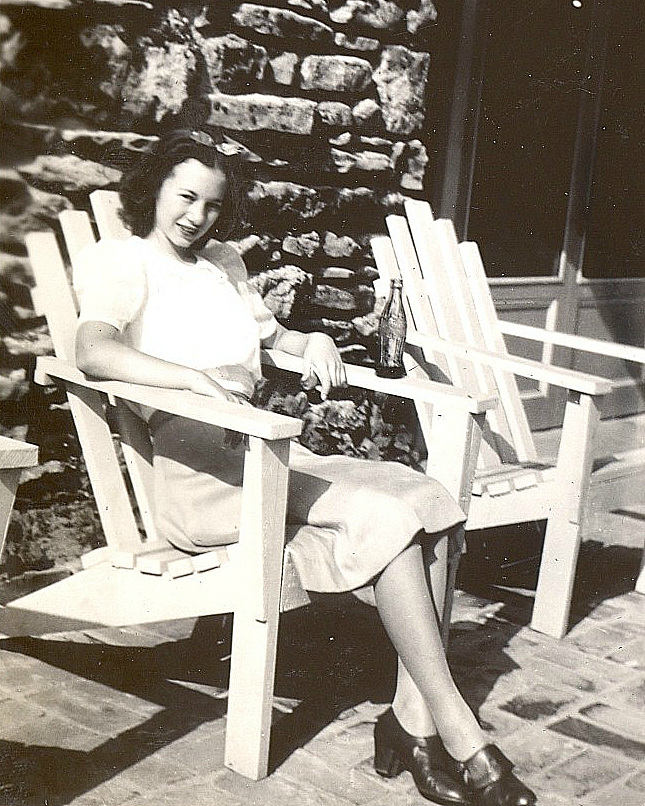 Betty Parkes, a Coke and a smile. Seated in a venerable (at least from an American perspective) Adirondack style chair, at Oakwood Acres Stables, Lynchburg, Tennessee,1940. Submitted to the VPTP for the Furniture theme.