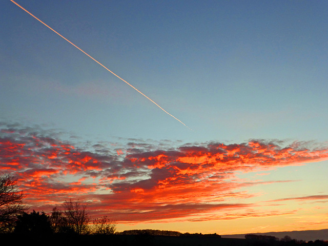 Sunset with a contrail.