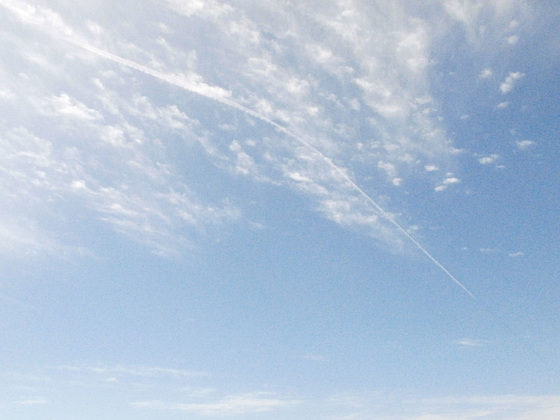 Wispy clouds and a vapour trail