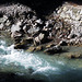 Grey rocks and ice-blue mountain water.