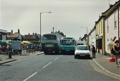 Norfolk Green (Go-West Travel) 105 (VRC 605Y) and 401 (F401 XWR) in Wells-next-the-Sea – 6 Aug 1999 (420-08A)