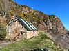 The stone cottage at the base of the cliff path to McFarquhar's Cave