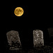 The full moon rises over three gravestones!