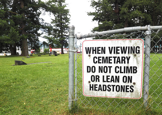 What a crazy world we live in...... you have to tell people not to climb on headstones in a graveyard.