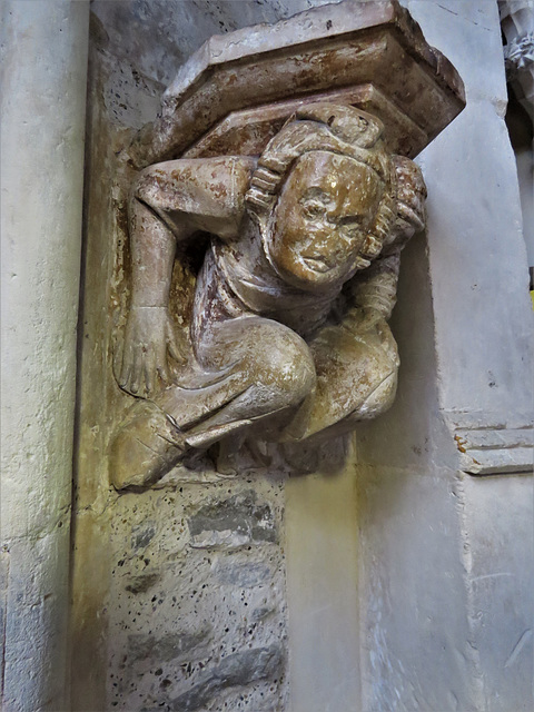 winchelsea church, sussex c14 atlas figure supporting a corbel on his back