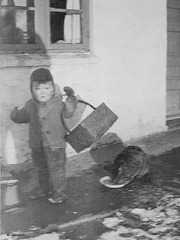 My elder brother feeding the cat, 1943.
