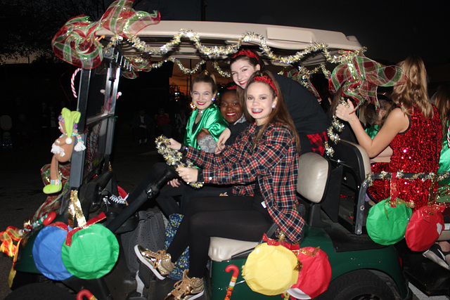 My golf cart in the Christmas Parade, decorated and driven by a grand daughter :))  loaded with her friends :)