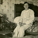 Pajama-Clad Man Sitting on a Quilt-Covered Bed