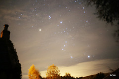 Orion shining through cloudy skies