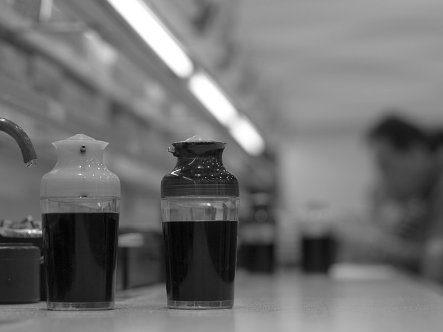 Soy sauce containers on a sushi bar