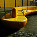 Yellow Tanker Docks Beside Matching Benches