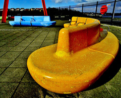 Yellow Tanker Docks Beside Matching Benches