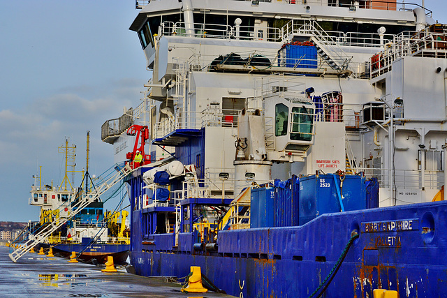 Docked along side a Dredger