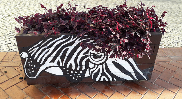 Street art on flowerbed.