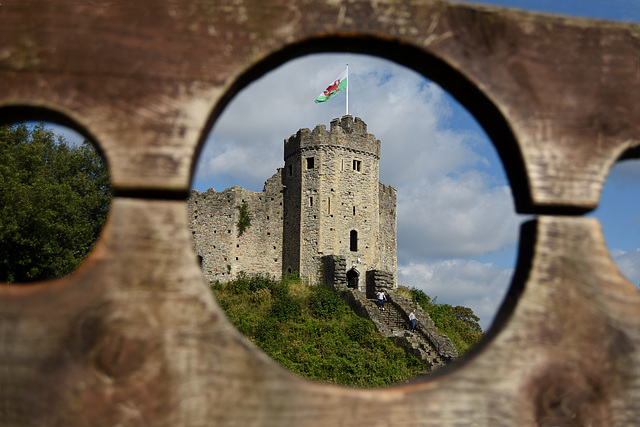 Cardiff Castle seen through medieval stocks.