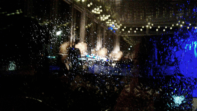 Rain drops and reflections a window on a wet night