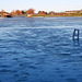 The blue sky reflected in the ice