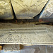 bakewell  church, derbs (91)coped coffin lid cross slab with stepped cross and rough  lettering, perhaps c12 or earlier