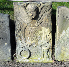 bakewell  church, derbs (97)part of a c18 chest tomb, with cherub, ouroboros and hourglass