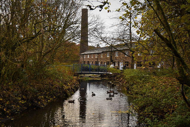 Old mill cottages, and factory chimney.