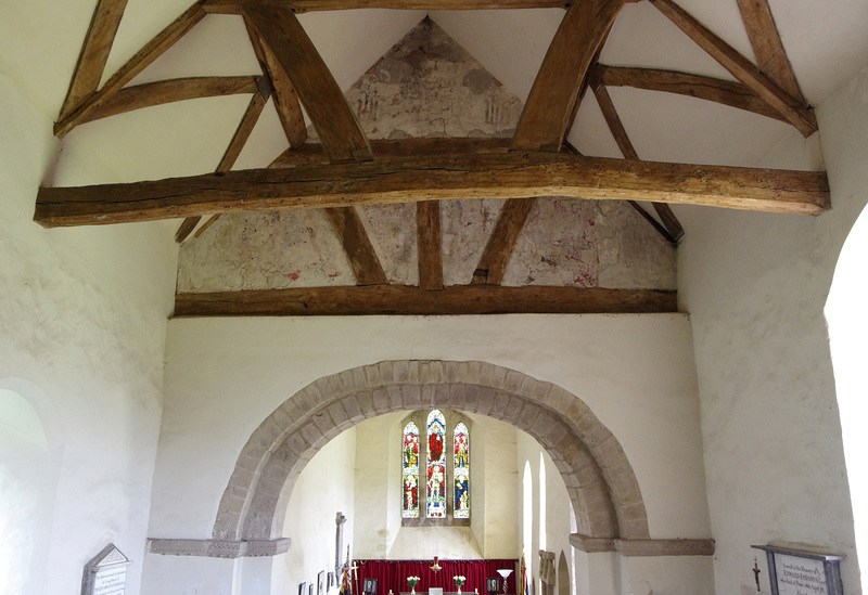 Medieval mural (faded) and norman arch