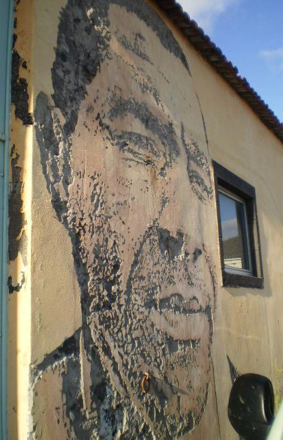 Portrait carved on wall by Vhils.