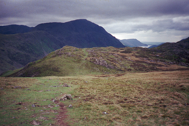 Looking back across Haystacks (597m) towards Ennerdale Water and Angler’s Crag just visible behind the dark form of Pillar in the centre (Scan from May 1990)