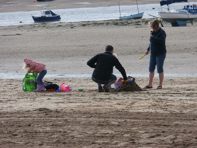 Braving the wind - a family trying to make a sandcastle