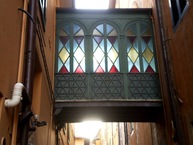 Upper passage with stained glass.