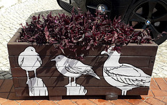 Street art on flowerbed.