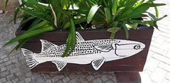 Street art on flower bed.